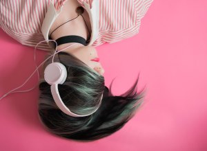 Girl with Pink Headphones and Hair over Eyes