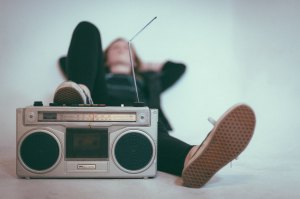 Person with Foot on Radio