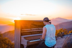 Man Playing Piano at Sunset